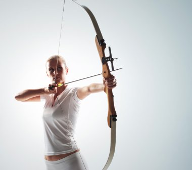 Beautiful woman aiming with bow and arrow clipart