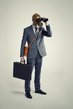 Businessman with gas mask looking through binoculars clipart