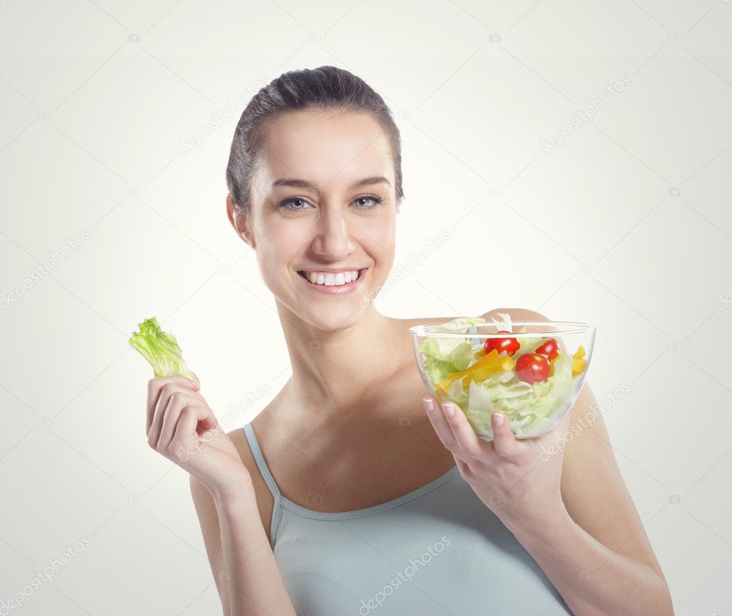 Girl holding plate with salad