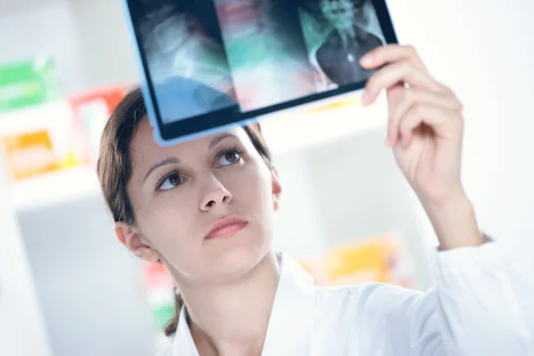Γυναίκα γιατρό κοιτάζοντας μια ακτινογραφία — Φωτογραφία Αρχείου