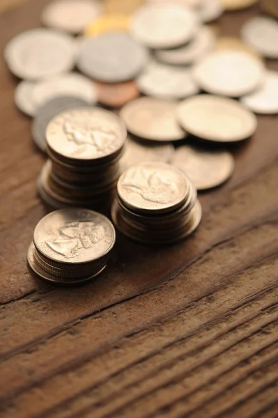 Old coins on the wooden table, shallow dof