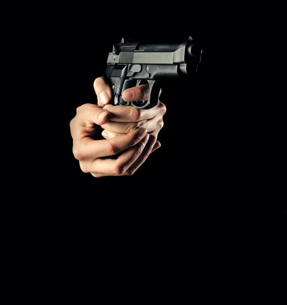Woman with a gun, black background, only hand — Stock Photo, Image