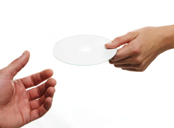 Female hand holding a blank disc, white background — Stock Photo, Image