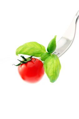 Tomato on a fork,isolated on white background clipart