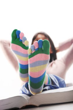 Student relaxing with his feet up on his desk, similar picture clipart