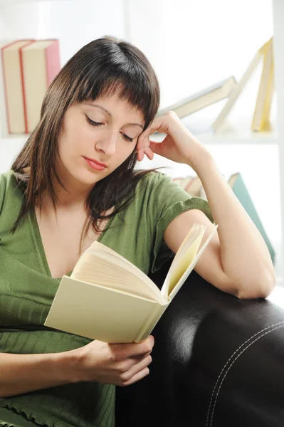 Portret van een jonge vrouw vrouw met boek, boekenplank op backgr — Stockfoto