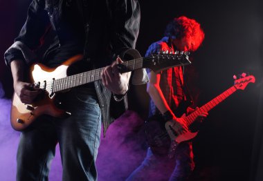 Rock musicians playing at a live concert clipart