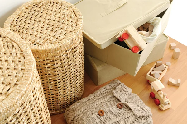 Wicker containers for home, on wooden floor, top view