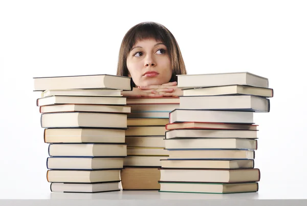 Junge Frau hinter einem großen Stapel Bücher — Stockfoto