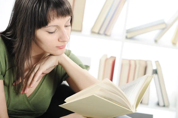 Bright picture of young woman woman with book , bookshelf on bac — Stock Photo, Image