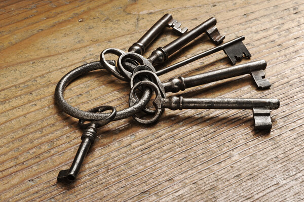 Old keys on a wooden table, close-up