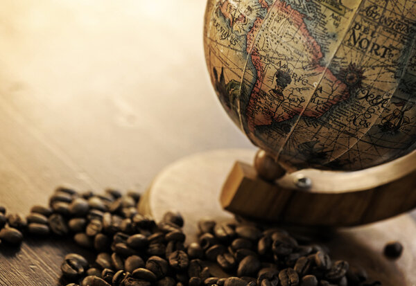 Old globe with coffee beans, focus on south america