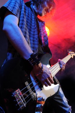 A bassist plays at a live concert clipart