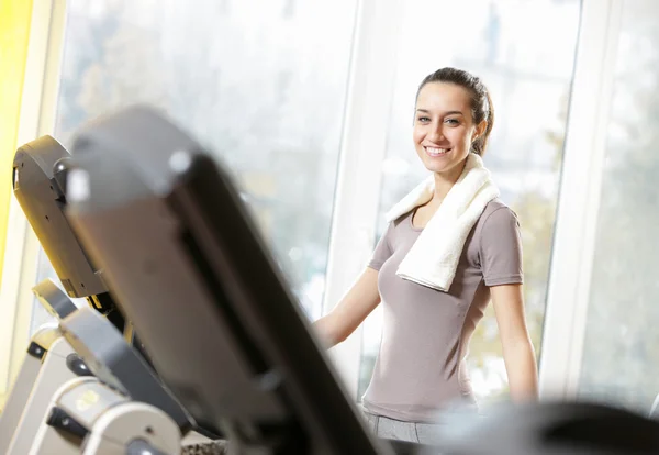Portrait of young woman on treadmills — Stock Photo, Image
