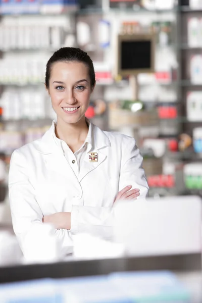 Portrait of young healthcare worker and background pharmacy. — Stock Photo, Image