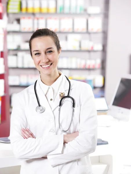 På apotek. en leende ung kvinna farmaceut med stetoskop — Stockfoto