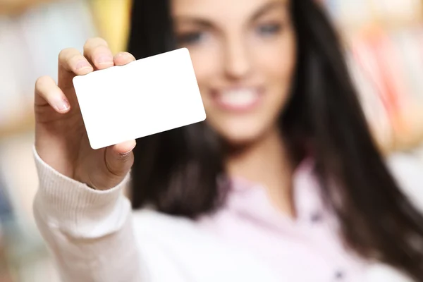 Lächelnde junge Frau zeigt Visitenkarte - Kopierraum. — Stockfoto