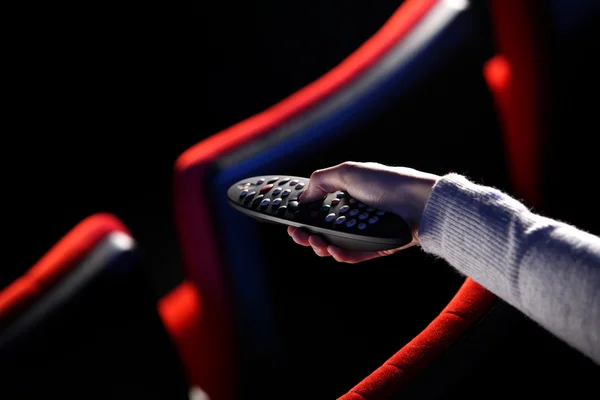 stock image Closeup of a hand holding a remote control TV, in the background