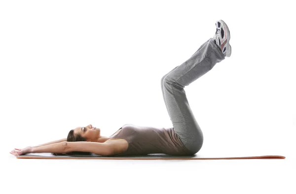 Fitness woman doing fitness exercise on mat . White background — Stock Photo, Image