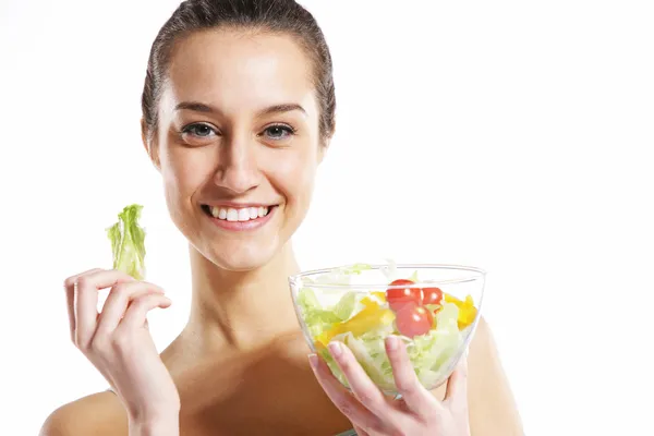 Girl holding plate with salad on white background — Stock Photo, Image