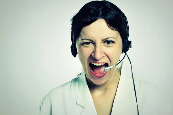 Portrait of angry girl with headset — Stock Photo, Image