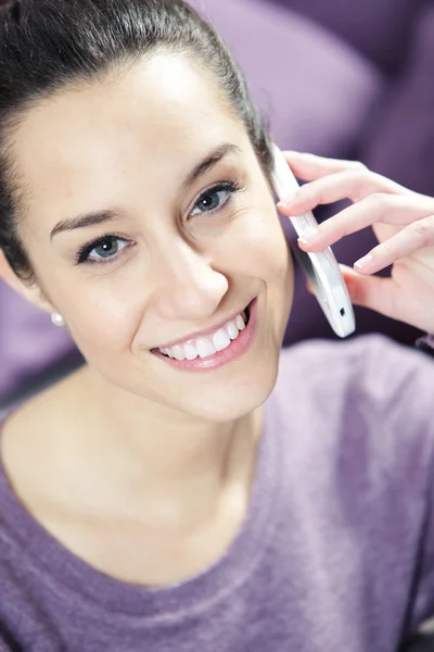 Young smiling woman on phone — Stock Photo, Image