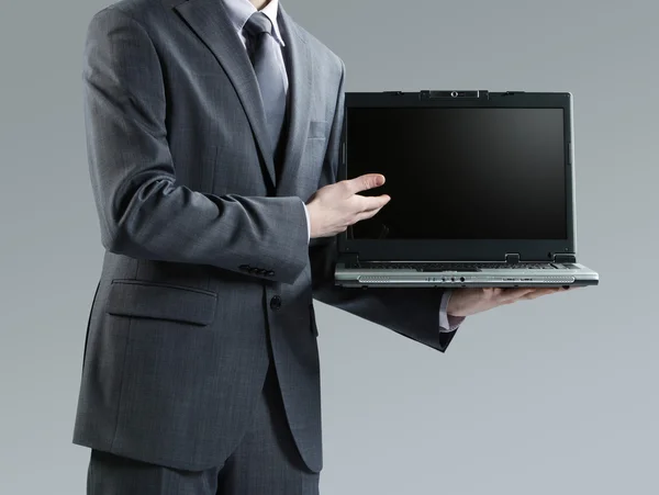 Biznesmen posiadania swojego laptopa — Zdjęcie stockowe