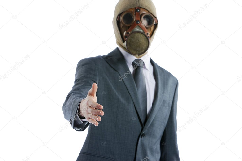 Portrait of businessman in a gas mask offering for handshake