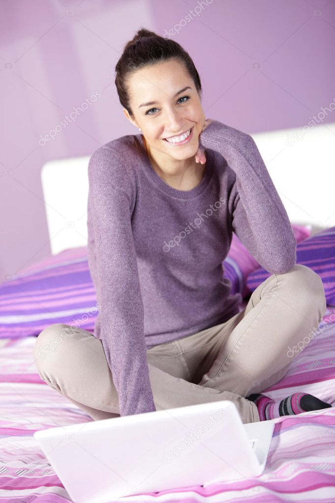 Woman in bed while using laptop