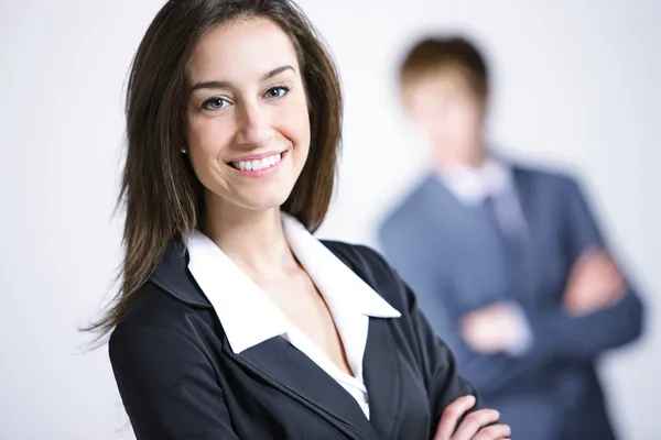 Attractive businesswoman with her arms crossed.Businessman on ba — Stock Photo, Image
