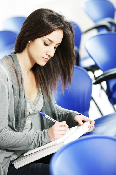 Young female is writing notes — Stock Photo, Image