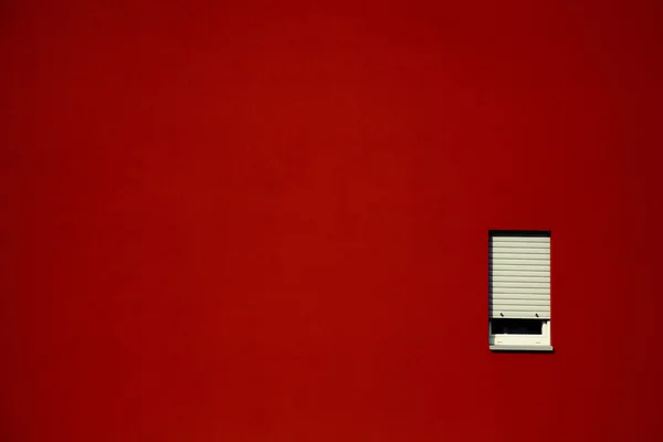 stock image White window on the red wall