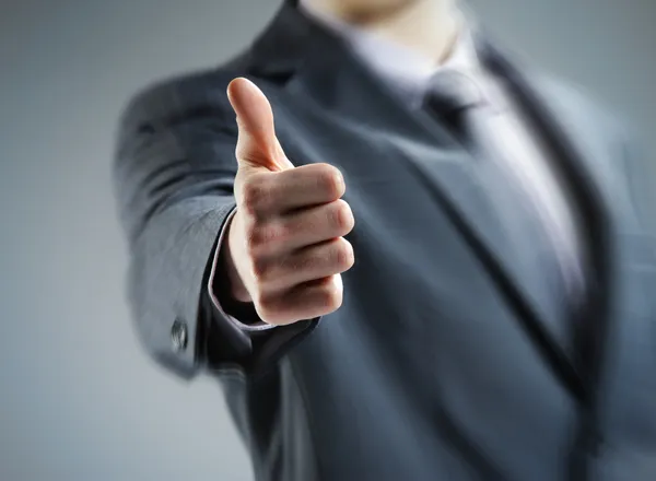 Close-up of a young businessman showing thumbs up. — Stock Photo, Image