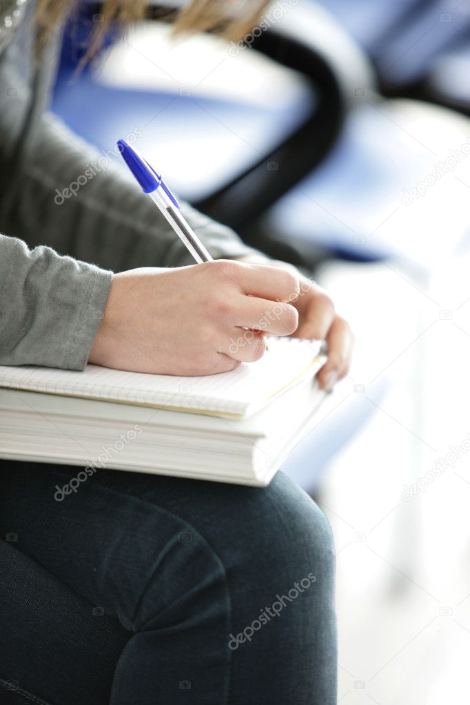 Young female is writing notes