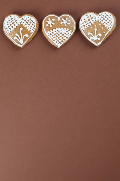 Gingerbread hearts on brown — Stock Photo, Image