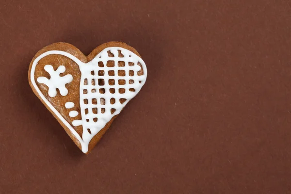 Gingerbread heart on brown — Stock Photo, Image