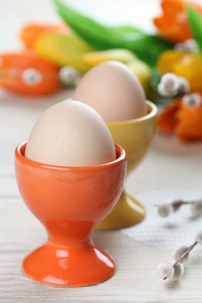 Vejce v oranžové a žluté eggcups — Stockfoto
