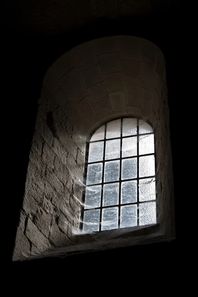 Stock image Old castle window in darkness