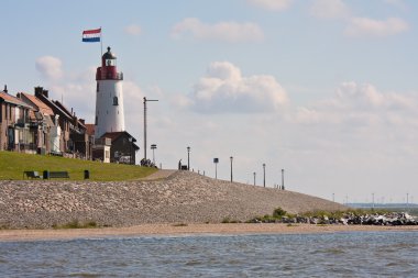 Seacoast with lighthouse of Urk, fishing village in the Netherla clipart