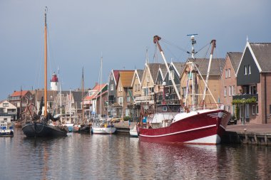 Traditional and modern fishing cutter in the harbor of Urk, the clipart