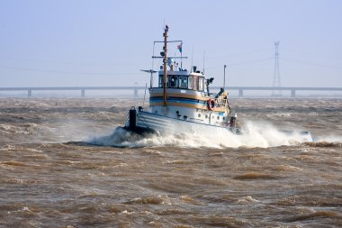 Tugboat crossing the storm clipart