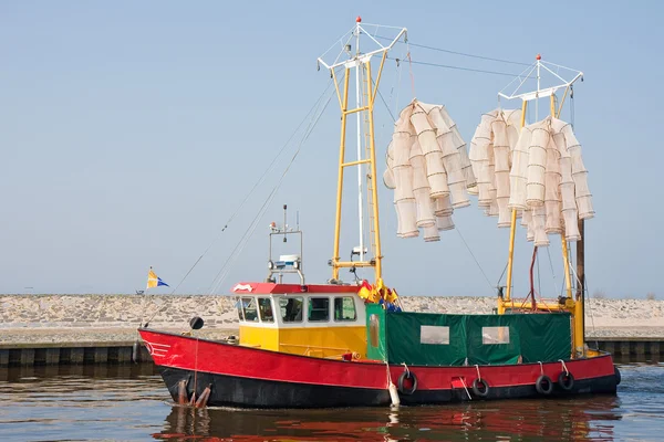 Fishing ship with nets leaving the harbor — Stock Photo, Image