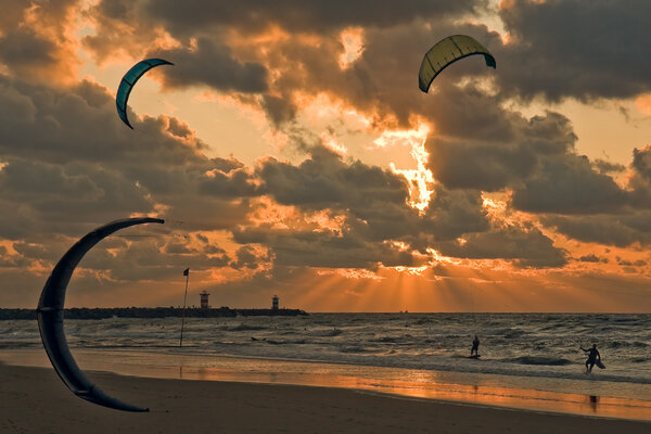 Kite surfing in the sunset at the beach of Scheveningen, the Ne