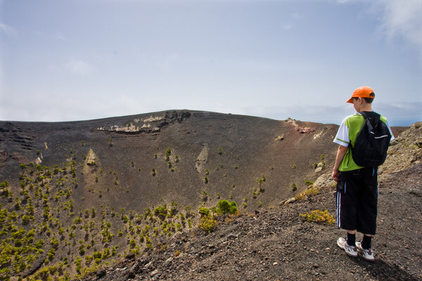 Boy near a big volcano at La Palma, Canary Islands
