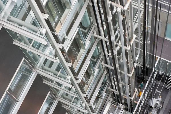 Looking down in an open steel lift shaft in a modern buldin — Zdjęcie stockowe