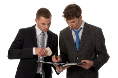 Businessman signing a contract. The deal is payed in cash money. clipart