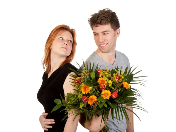 Man and woman in love with a beautiful bunch of flowers — Stock Photo, Image