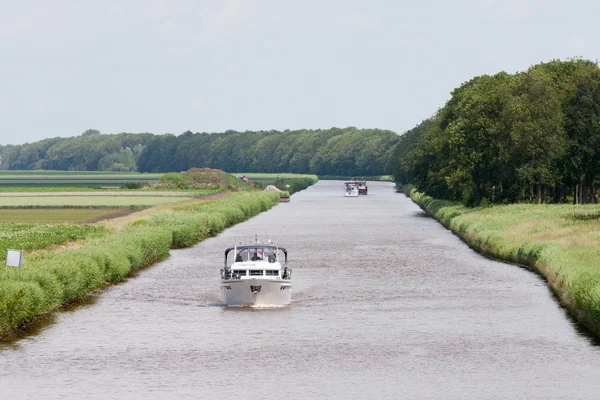 stock image Dutch canal with pleasure yachts through green meadows