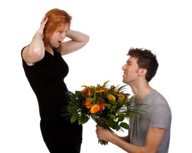 Young man offers his surprised girlfriend a large bouquet of flo clipart