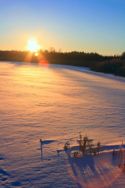 Winter sunset. Frozen lake clipart